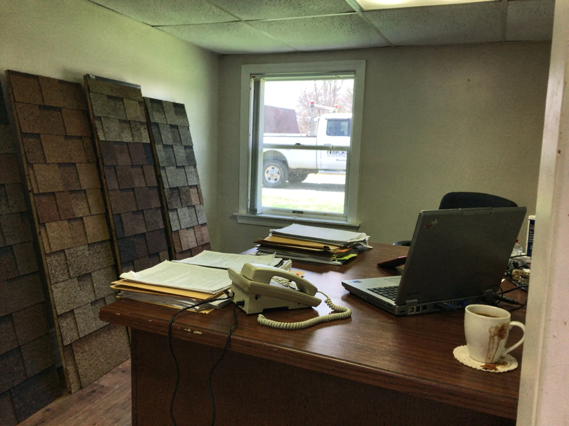 Office phone and laptop at a roofing company